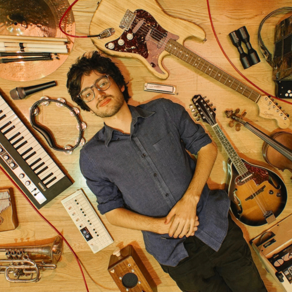 Ethan French lying down surrounded by instruments